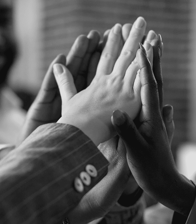 Acumate Solutions Partner in South Africa | A diverse group of people joyfully raising their hands in the air, celebrating together in a lively atmosphere.